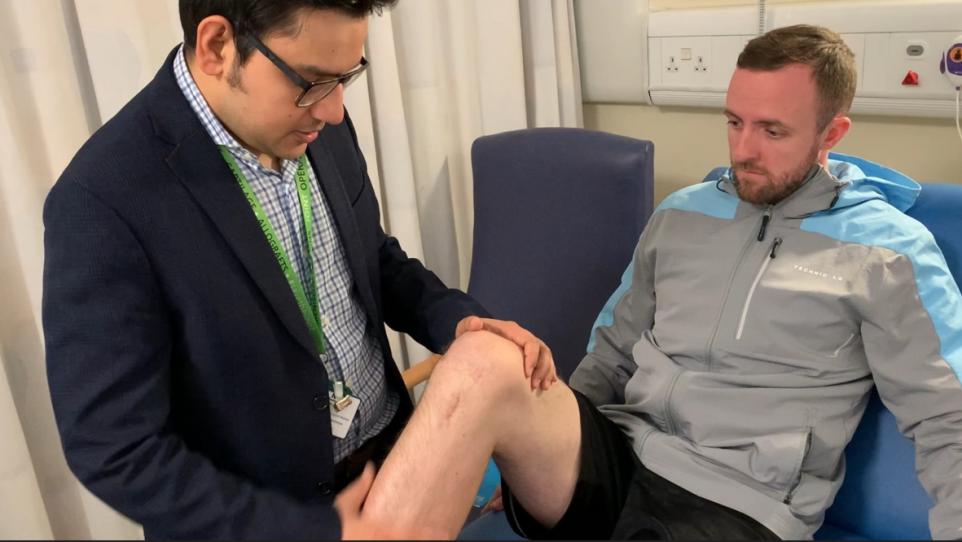 Surgeon, Mr Rahul Bhattacharyya examines patient Andrew Pollock's knee (Image: NHSLanarkshire)